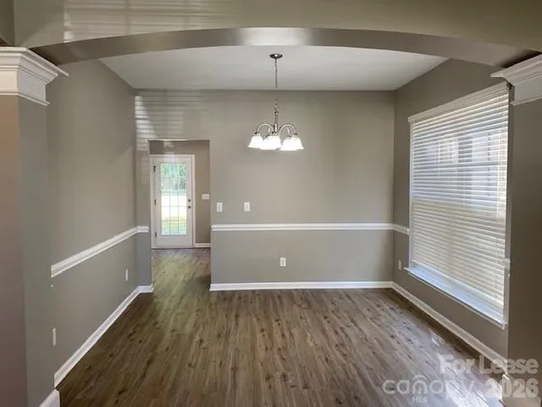 a view of a room with window and wooden floor