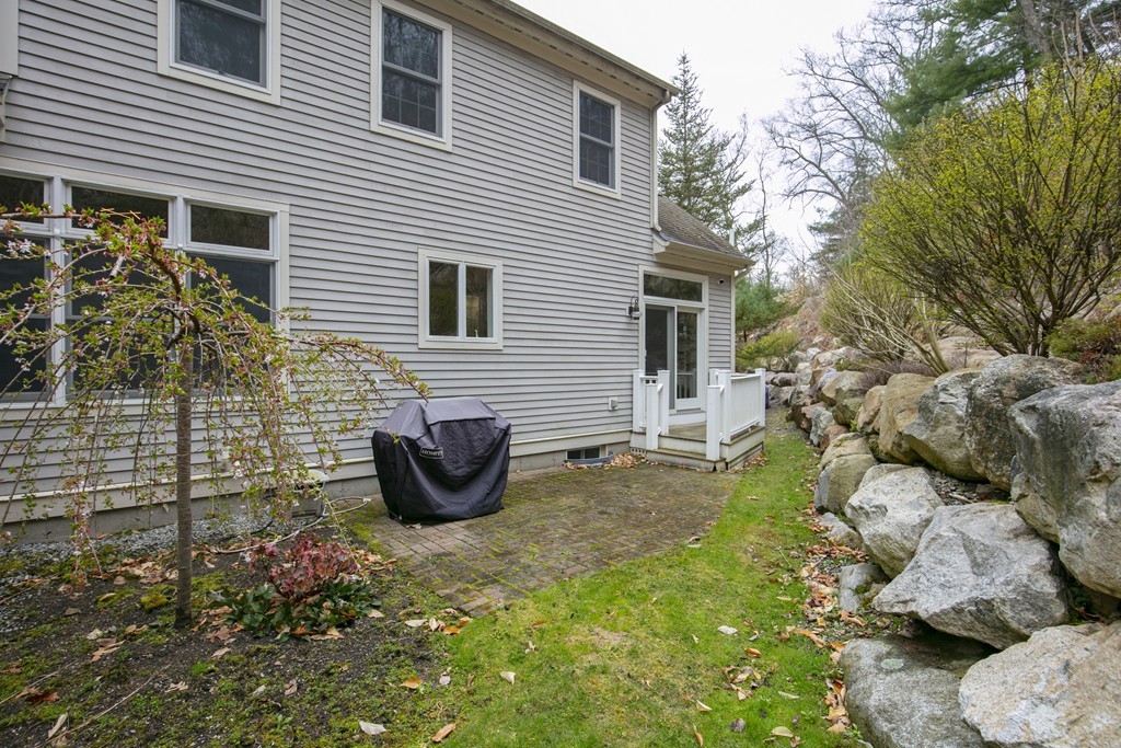 9 Chestnut Lane, Unit 9 Lexington, MA 02421 - Photo 31 of 32 a view of a backyard with table and chairs potted plants and large tree
