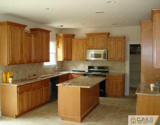 2 Stark Place Edison, NJ 08820 - Photo 3 of 10 a kitchen with stainless steel appliances granite countertop a stove a sink a refrigerator and a microwave