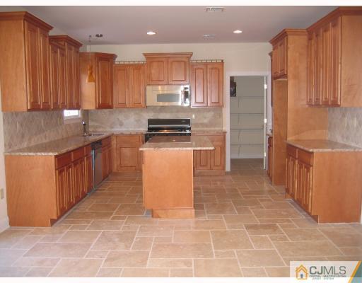2 Stark Place Edison, NJ 08820 - Photo 5 of 10 a kitchen with stainless steel appliances granite countertop a stove a sink dishwasher and a refrigerator with wooden cabinets