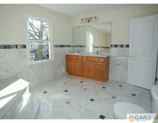 2 Stark Place Edison, NJ 08820 - Photo 9 of 10 a bathroom with a granite countertop sink a mirror and a bathtub