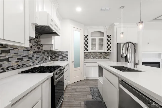 a kitchen with a sink stove and cabinets