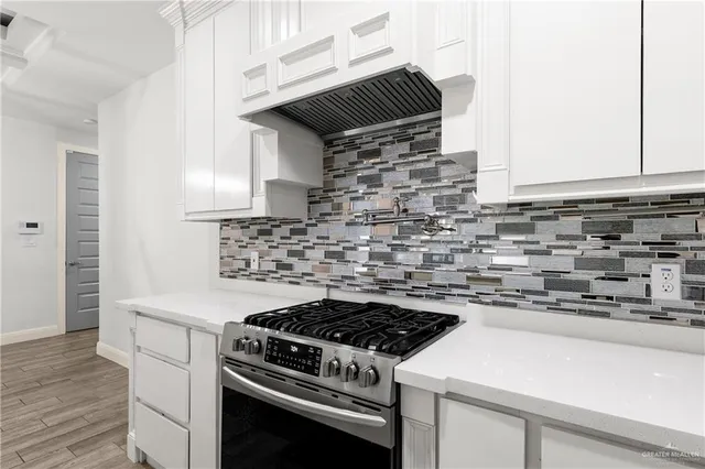 a stove top oven sitting inside of a kitchen