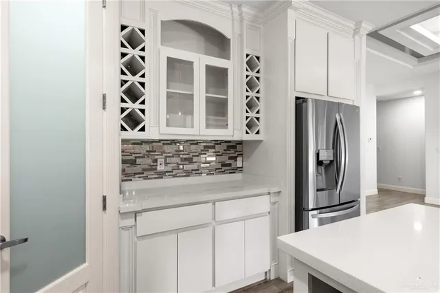 a kitchen with stainless steel appliances a refrigerator and cabinets