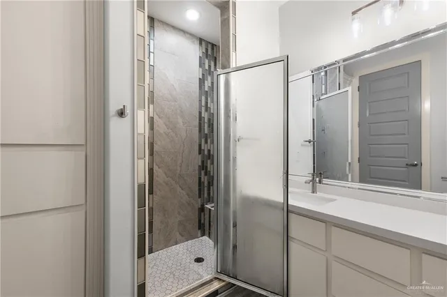 a bathroom with a shower and a sink