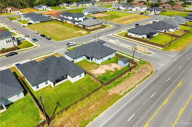 an aerial view of residential houses with outdoor space