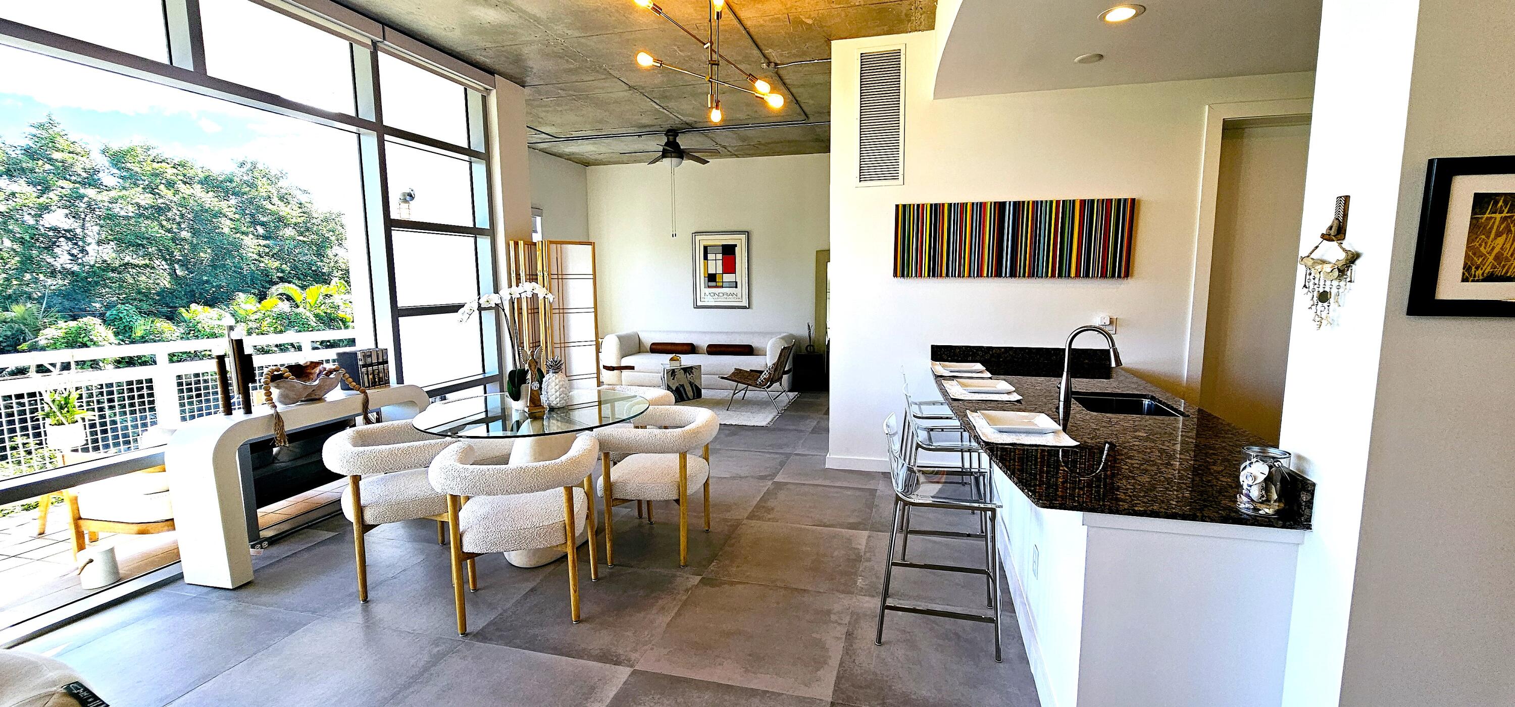 365 Southeast 6th Avenue, Unit 305 Delray Beach, FL 33483 - Photo 14 of 49 a living room with furniture a flat screen tv and a large window