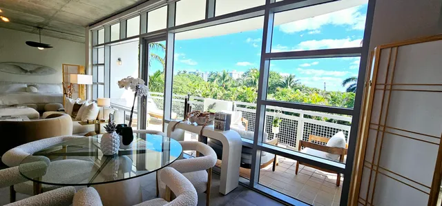 a living room with furniture and floor to ceiling windows