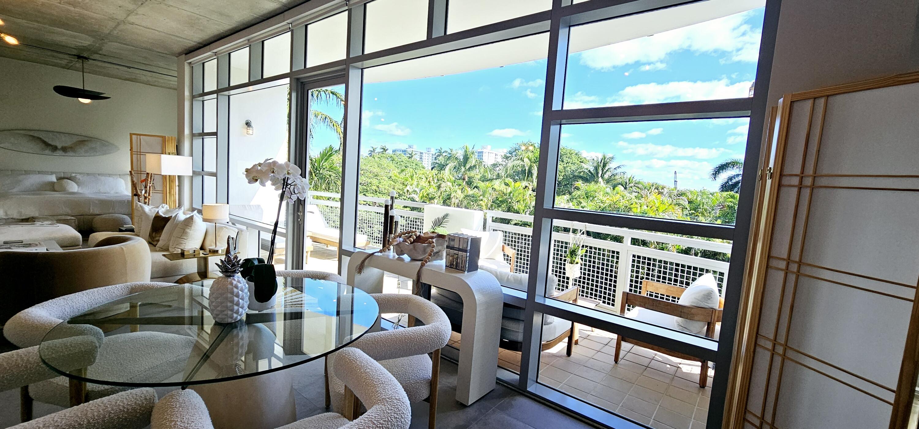 365 Southeast 6th Avenue, Unit 305 Delray Beach, FL 33483 - Photo 17 of 49 a living room with furniture and floor to ceiling windows