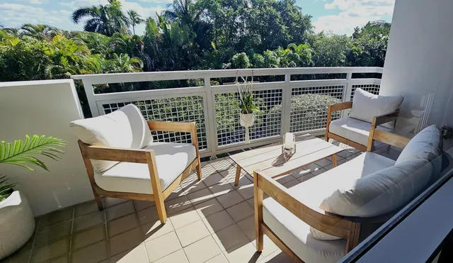 a view of a chairs and table in the balcony