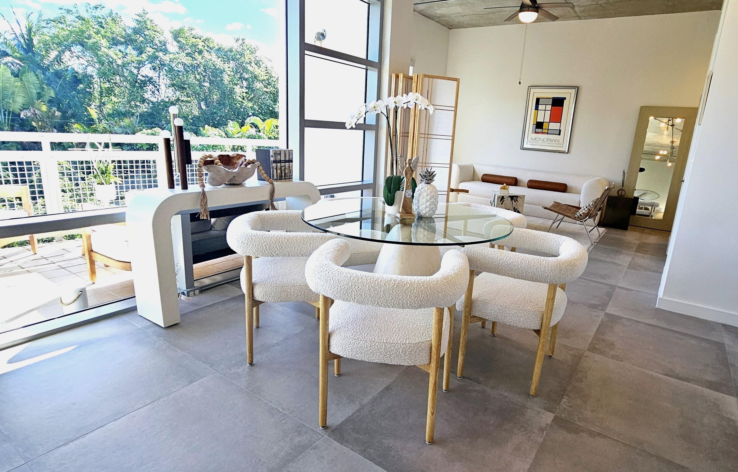 365 Southeast 6th Avenue, Unit 305 Delray Beach, FL 33483 - Photo 20 of 49 a dining room with furniture and a floor to ceiling window