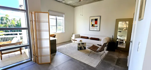 a living room with furniture and a window