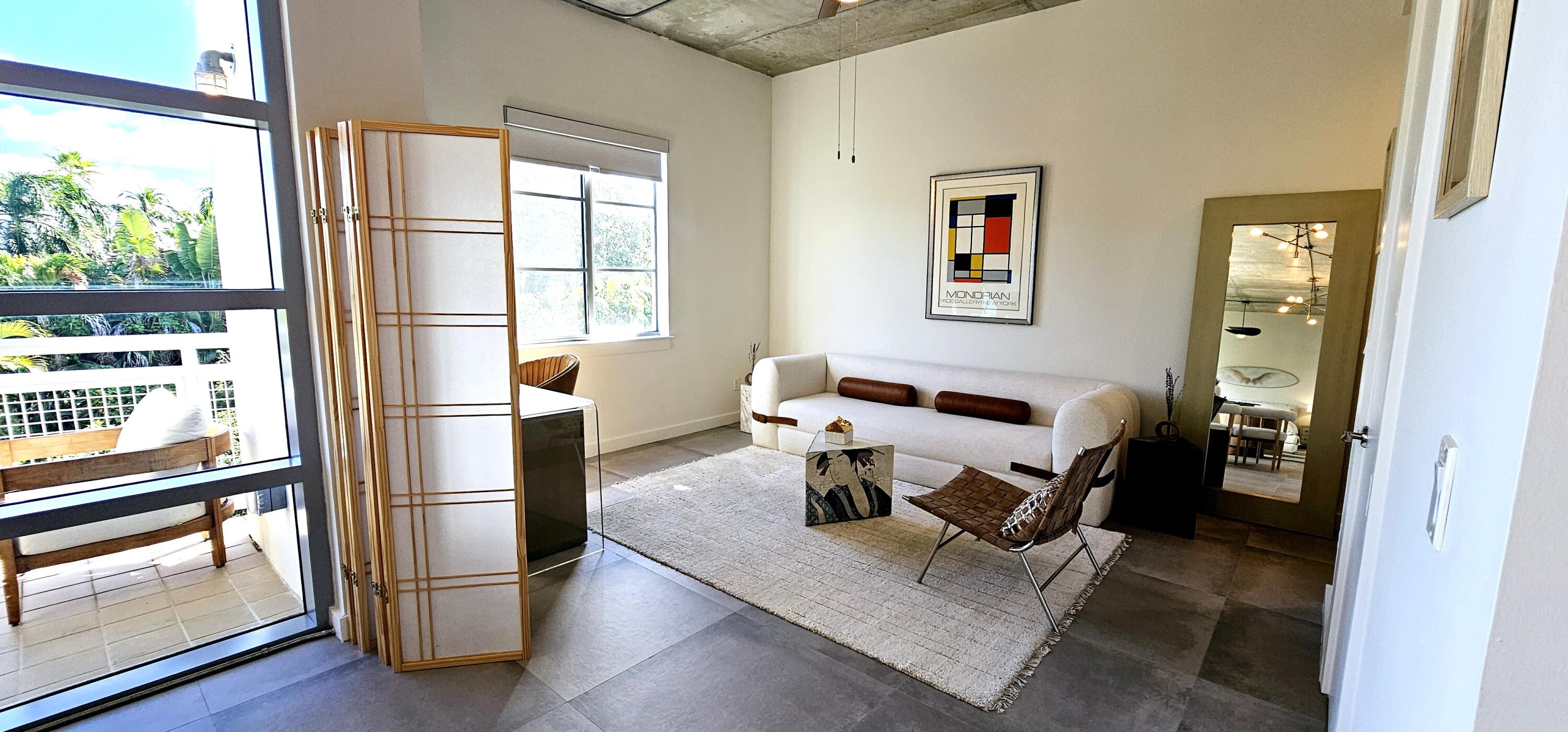 365 Southeast 6th Avenue, Unit 305 Delray Beach, FL 33483 - Photo 22 of 49 a living room with furniture and a window
