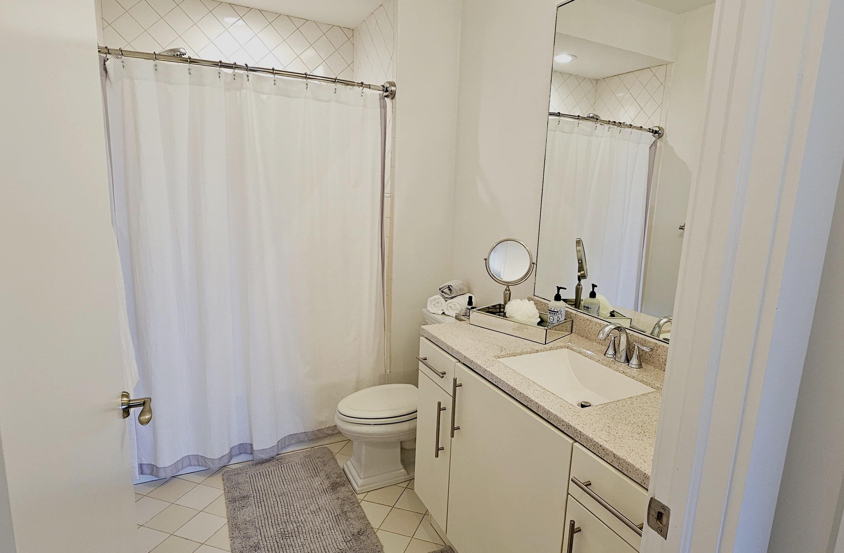 365 Southeast 6th Avenue, Unit 305 Delray Beach, FL 33483 - Photo 26 of 49 a bathroom with a sink a toilet and shower
