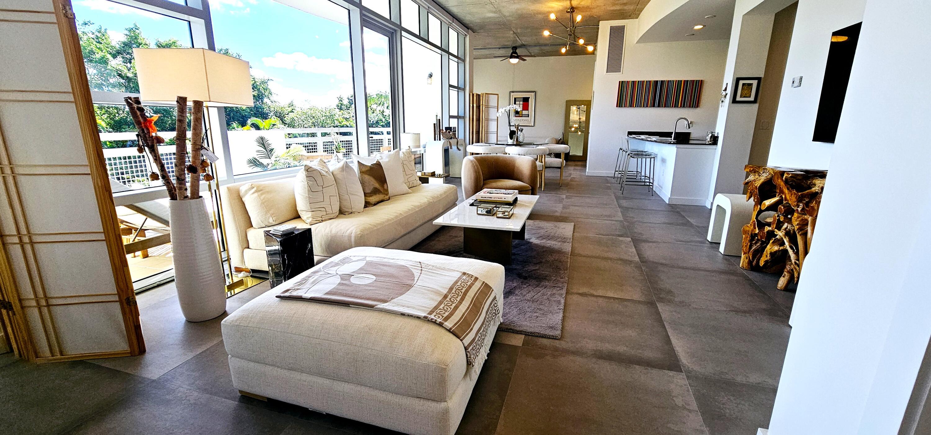 365 Southeast 6th Avenue, Unit 305 Delray Beach, FL 33483 - Photo 28 of 49 a living room with furniture a flat screen tv and a floor to ceiling window