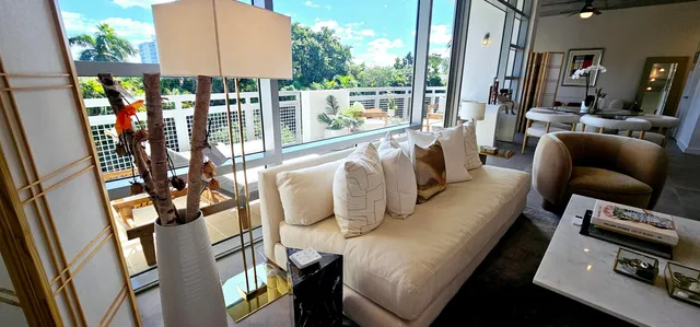 a living room with furniture and a floor to ceiling window
