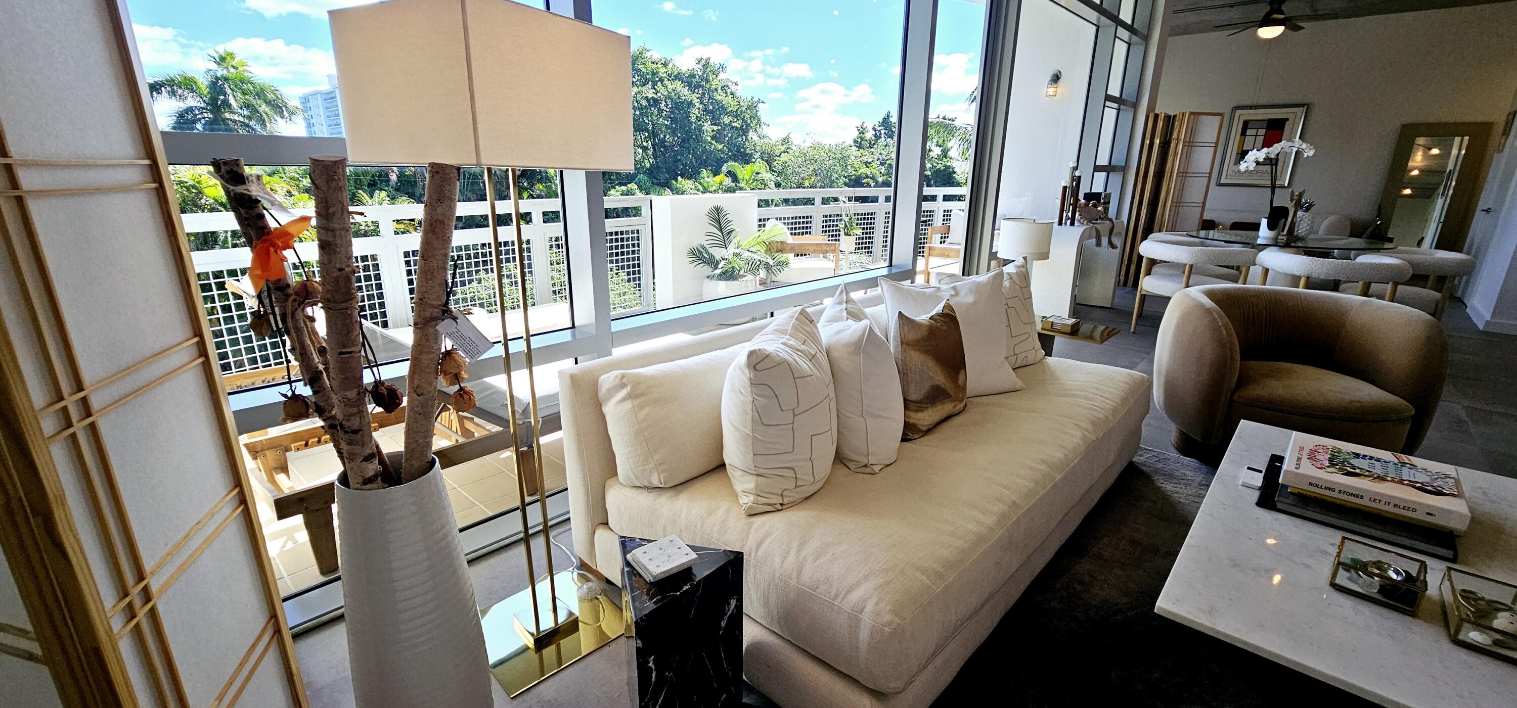 365 Southeast 6th Avenue, Unit 305 Delray Beach, FL 33483 - Photo 30 of 49 a living room with furniture and a floor to ceiling window