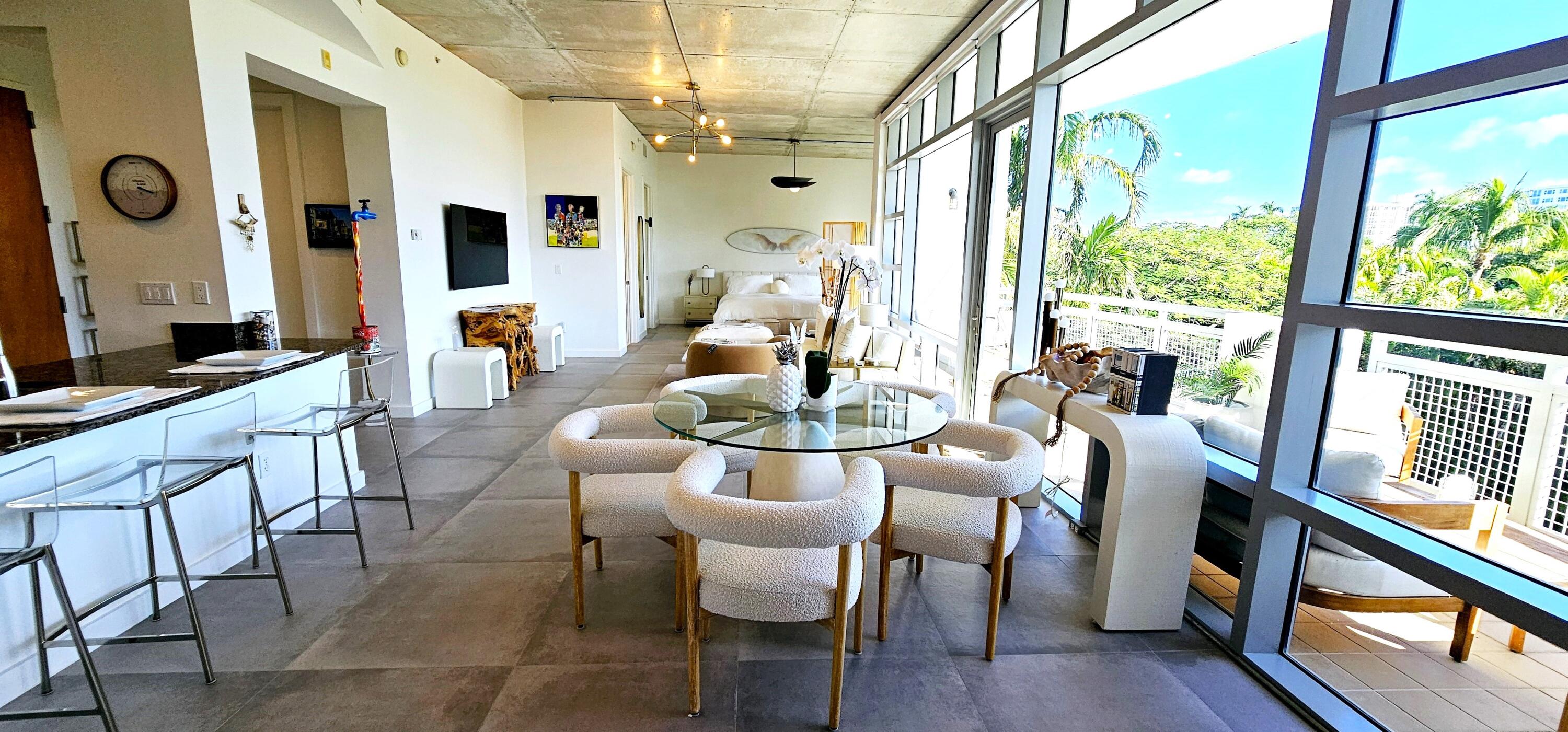 365 Southeast 6th Avenue, Unit 305 Delray Beach, FL 33483 - Photo 32 of 49 a view of a dining room with furniture window and wooden floor