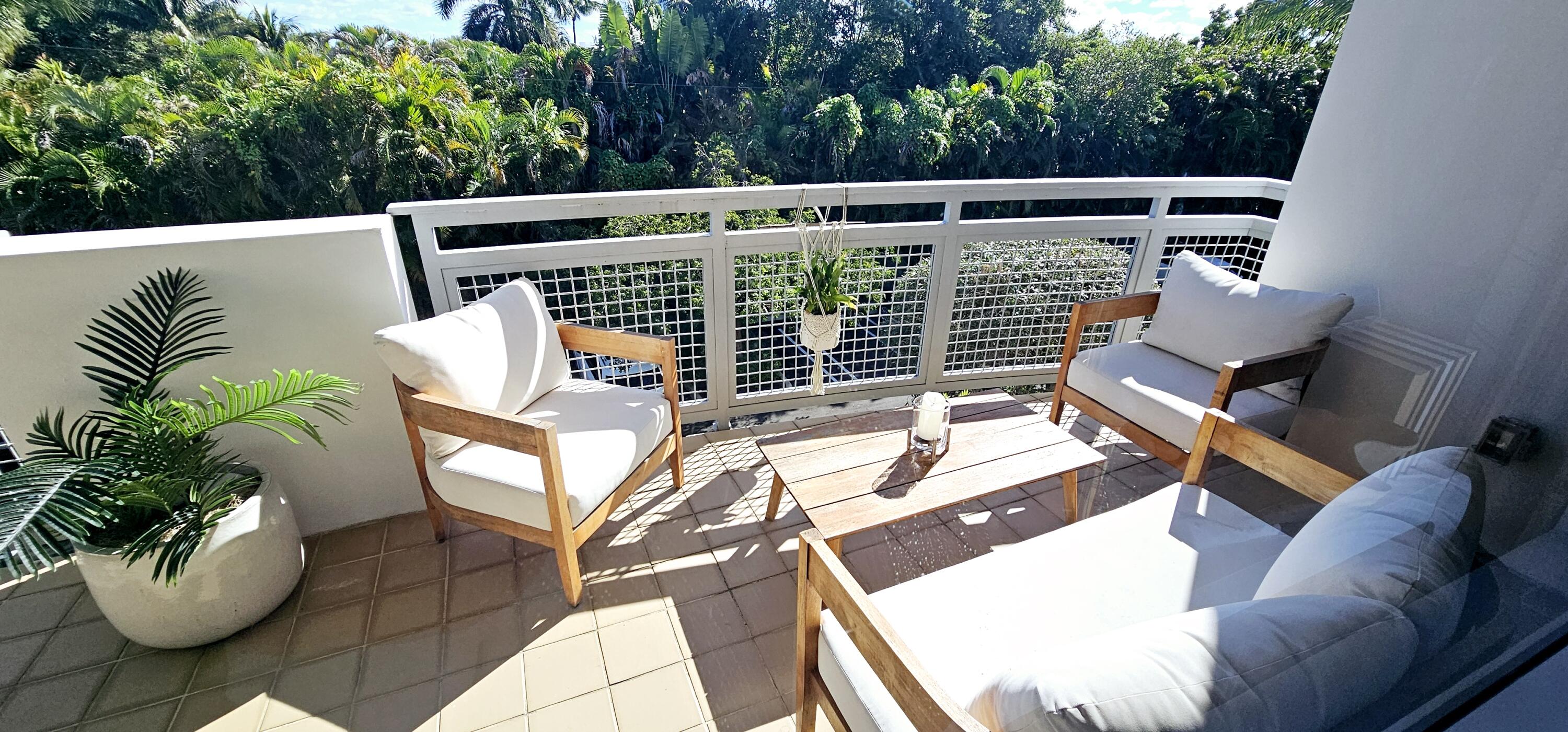 365 Southeast 6th Avenue, Unit 305 Delray Beach, FL 33483 - Photo 36 of 49 a view of outdoor sitting area with chairs and potted plants