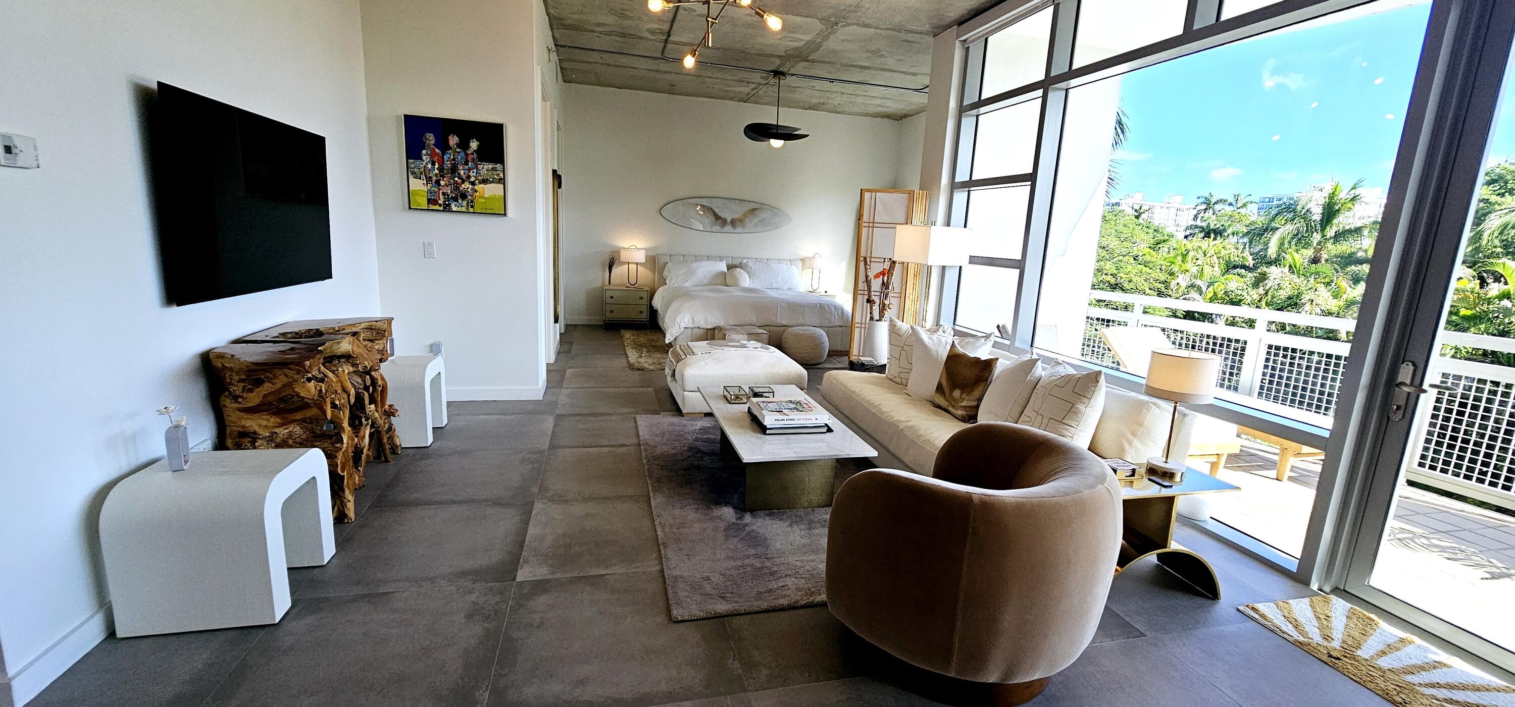 365 Southeast 6th Avenue, Unit 305 Delray Beach, FL 33483 - Photo 37 of 49 a living room with furniture and a flat screen tv