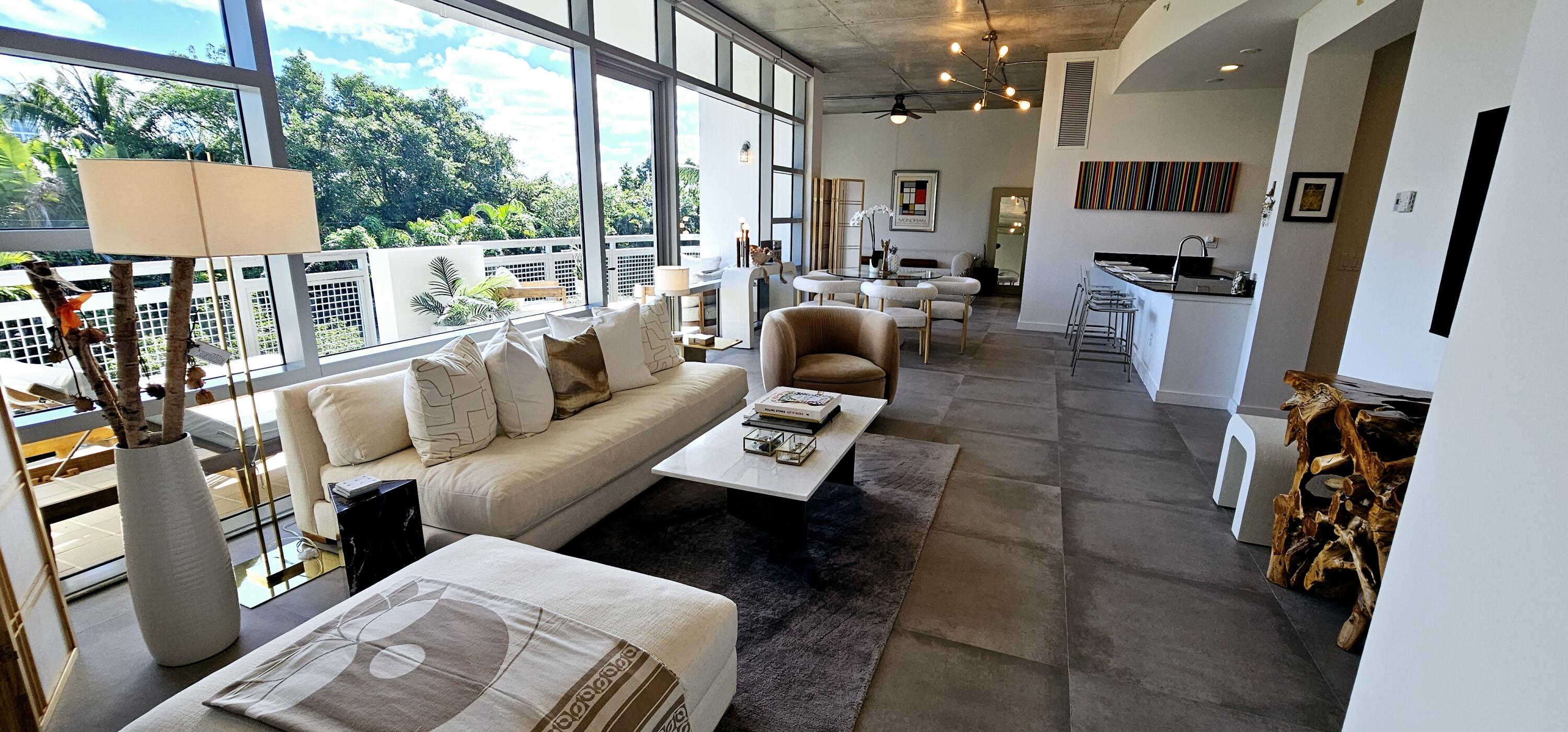 365 Southeast 6th Avenue, Unit 305 Delray Beach, FL 33483 - Photo 38 of 49 a living room with furniture and a flat screen tv