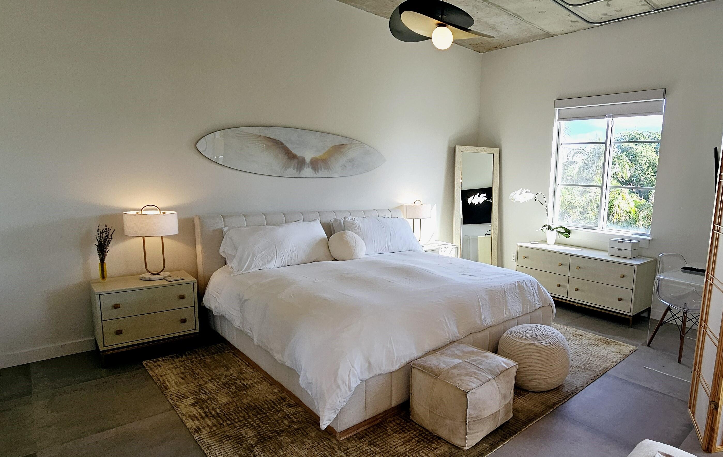 365 Southeast 6th Avenue, Unit 305 Delray Beach, FL 33483 - Photo 41 of 49 a bedroom with a bed and a chandelier