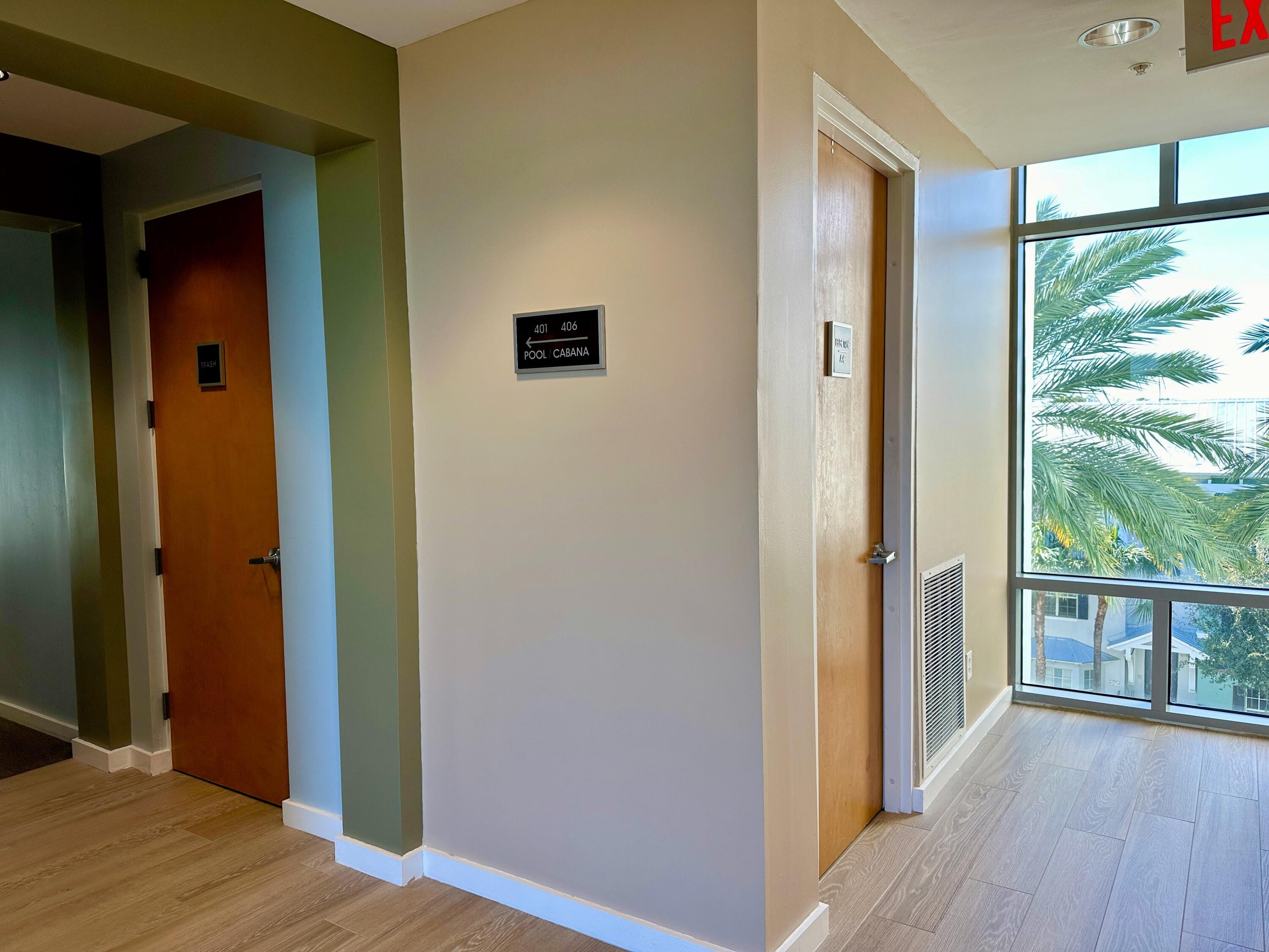 365 Southeast 6th Avenue, Unit 305 Delray Beach, FL 33483 - Photo 47 of 49 a view of a hallway with wooden floor and windows