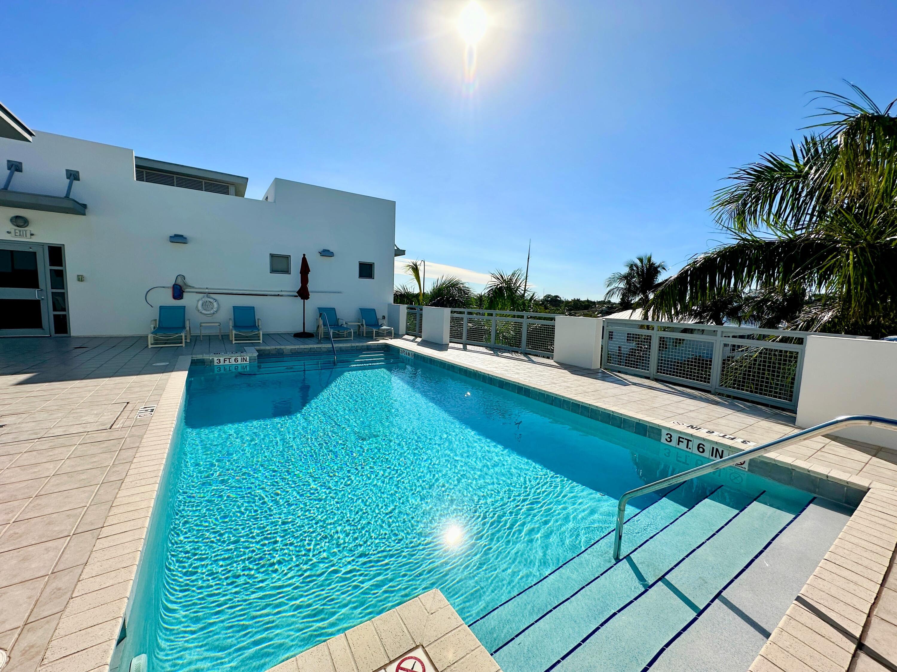 365 Southeast 6th Avenue, Unit 305 Delray Beach, FL 33483 - Photo 48 of 49 a view of a swimming pool with a patio