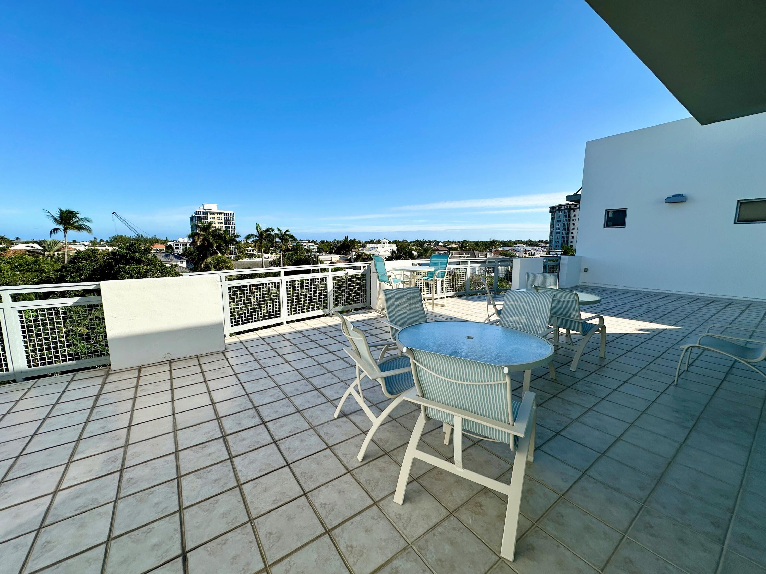 365 Southeast 6th Avenue, Unit 305 Delray Beach, FL 33483 - Photo 49 of 49 a view of a chairs and table in the terrace
