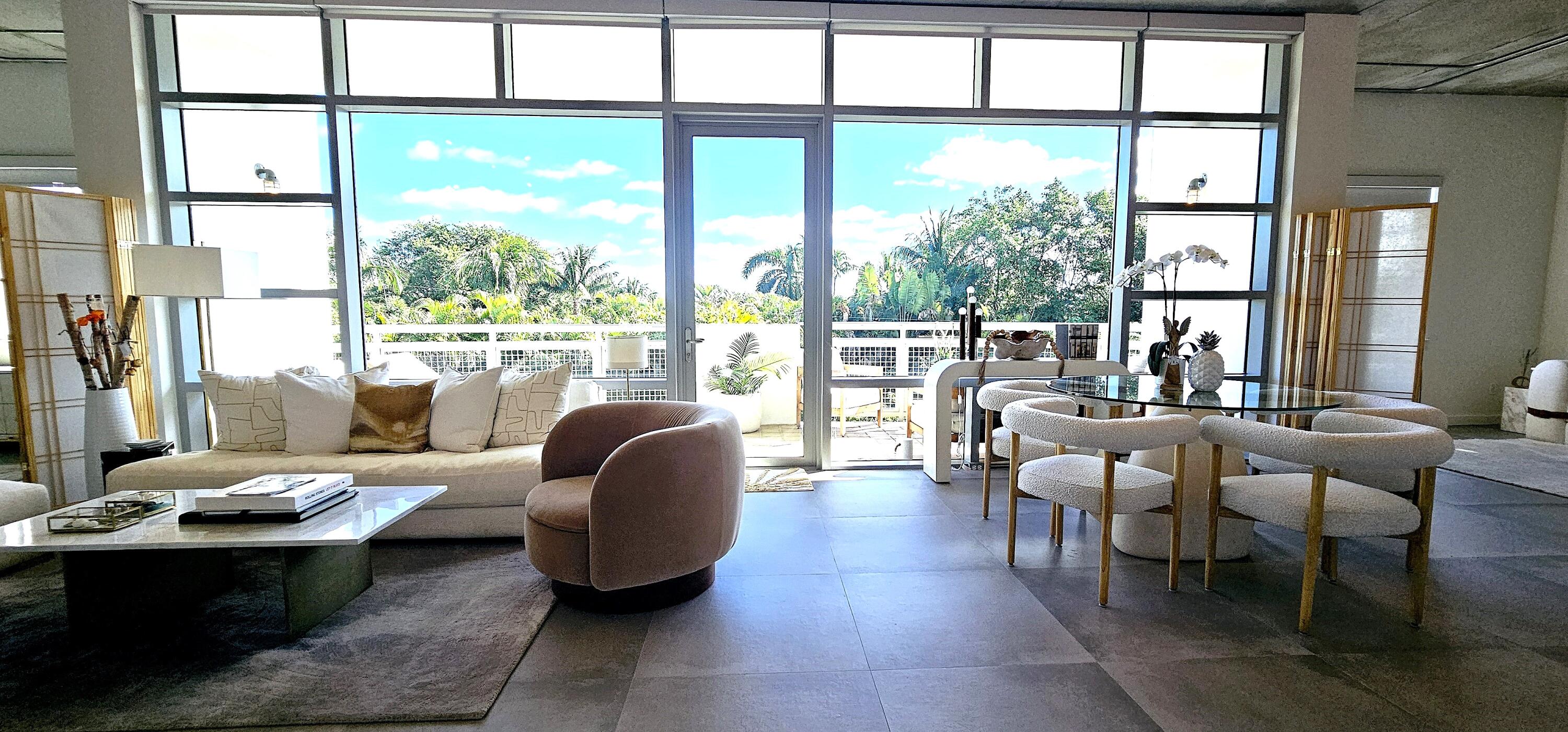365 Southeast 6th Avenue, Unit 305 Delray Beach, FL 33483 - Photo 6 of 49 a living room with furniture and a large window