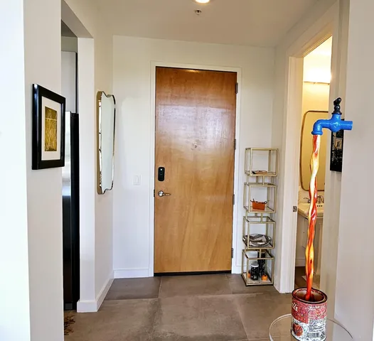a view of an entryway with wooden shelves