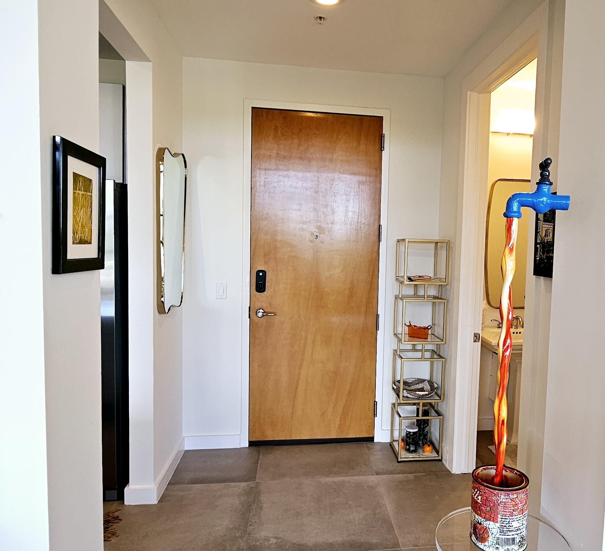 365 Southeast 6th Avenue, Unit 305 Delray Beach, FL 33483 - Photo 7 of 49 a view of an entryway with wooden shelves