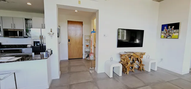 a view of a livingroom with furniture and a flat screen tv