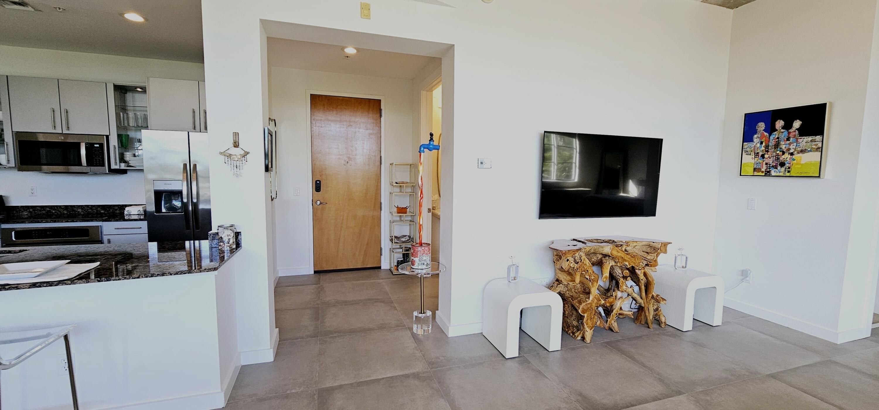 365 Southeast 6th Avenue, Unit 305 Delray Beach, FL 33483 - Photo 8 of 49 a view of a livingroom with furniture and a flat screen tv