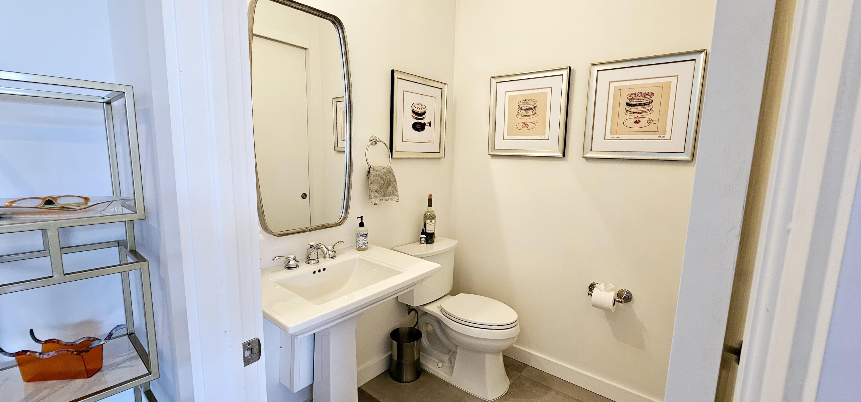 365 Southeast 6th Avenue, Unit 305 Delray Beach, FL 33483 - Photo 9 of 49 a bathroom with a toilet sink and mirror