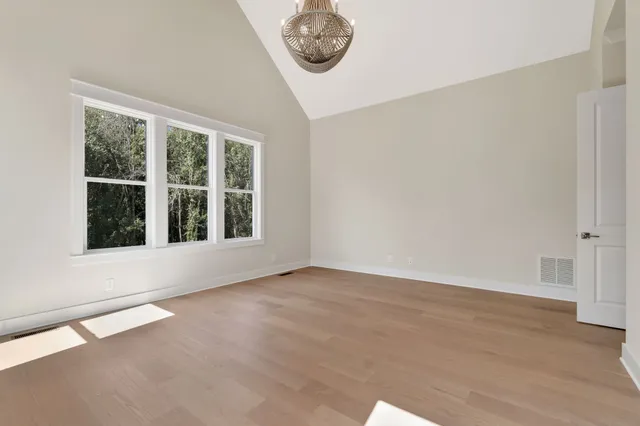 a bathroom with a sink a toilet and large mirror