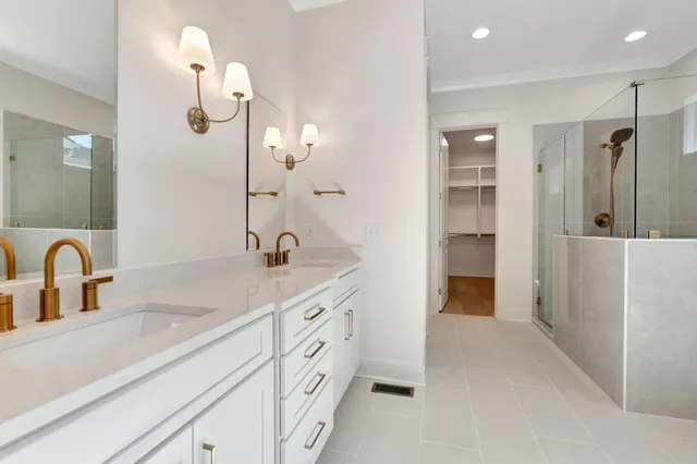 a bathroom with a granite countertop sink a toilet and shower
