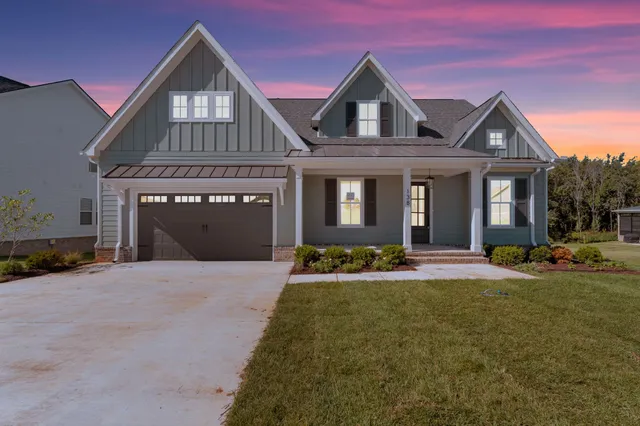 a front view of a house with garden