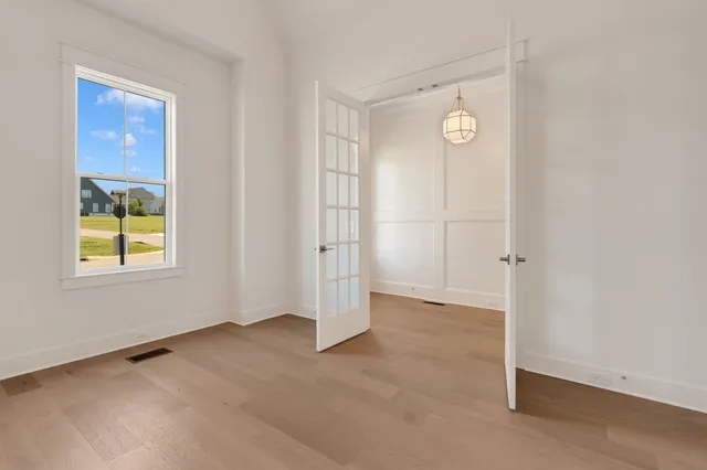 a view of a a dining room with furniture window and wooden floor