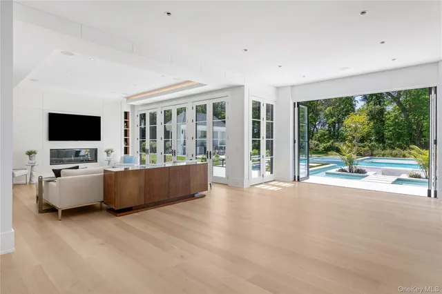 a view of a living room hardwood floor and a large window