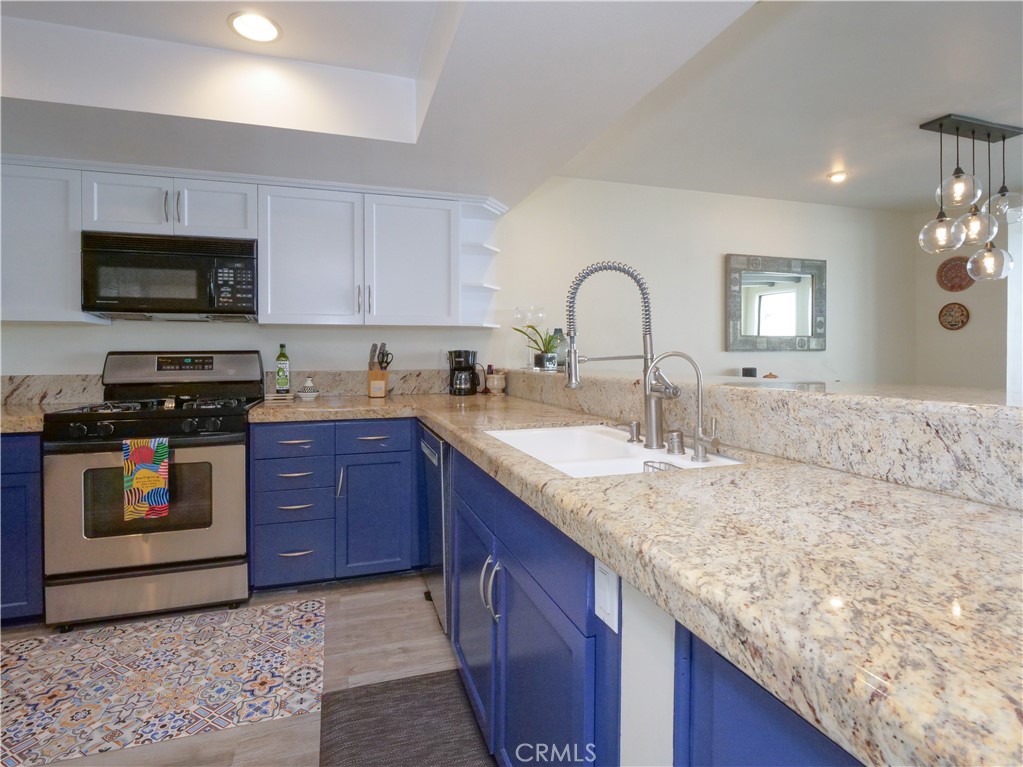 736 Gould Avenue, Unit 26 Hermosa Beach, CA 90254 - Photo 13 of 39 a kitchen with stainless steel appliances granite countertop a sink dishwasher stove and oven with granite countertops