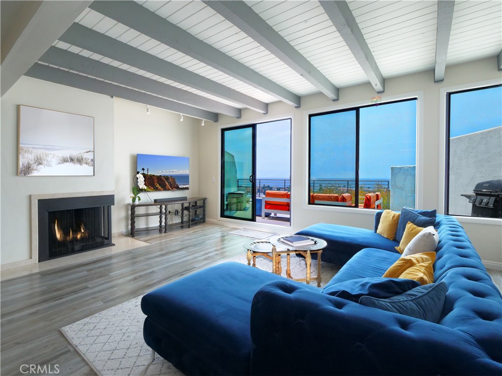 736 Gould Avenue, Unit 26 Hermosa Beach, CA 90254 - Photo 7 of 39 a living room with furniture fireplace and a large window