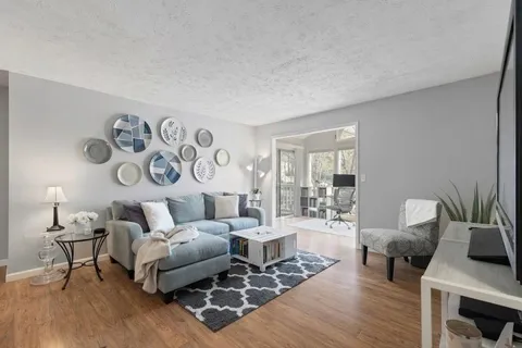 a living room with furniture and wooden floor