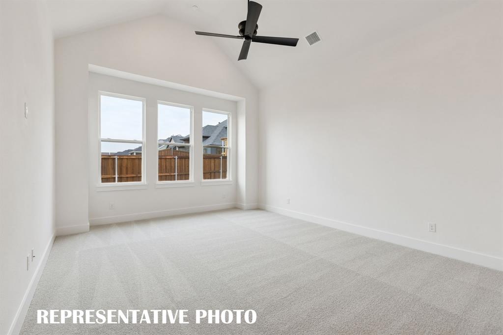 2122 Wakefield Lane Allen, TX 75013 - Photo 10 of 19 Your dreamy new owner's suite features high ceilings, a wall of windows, plush carpeting and so much more! REPRESENTATIVE PHOTO