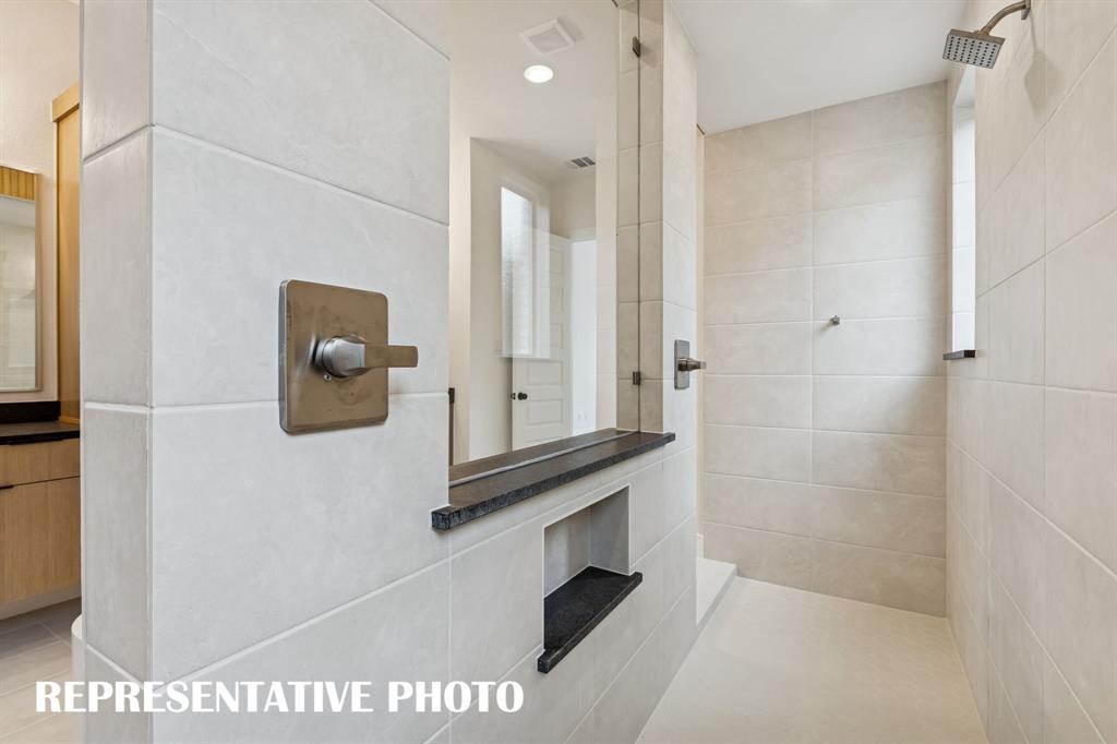2122 Wakefield Lane Allen, TX 75013 - Photo 12 of 19 Experience a spa like retreat every day in this wonderful bath with double walk through shower and freestanding tub. REPRESENTATIVE PHOTO