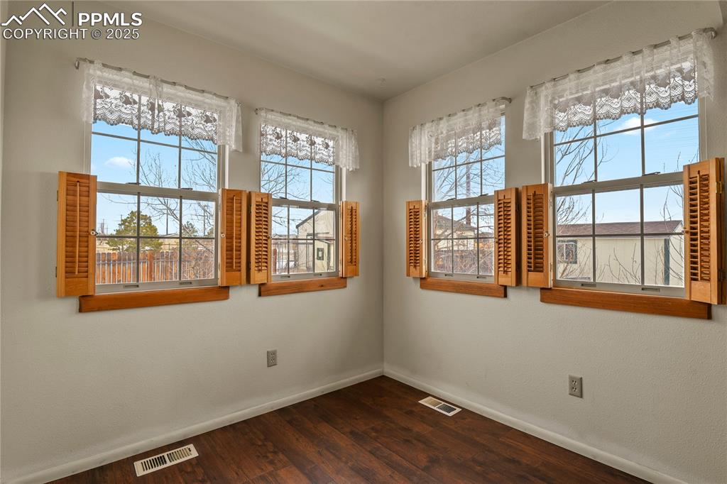 7875 Falcon Meadows Boulevard Peyton, CO 80831 - Photo 18 of 50 a view of an empty room with wooden floor and a window