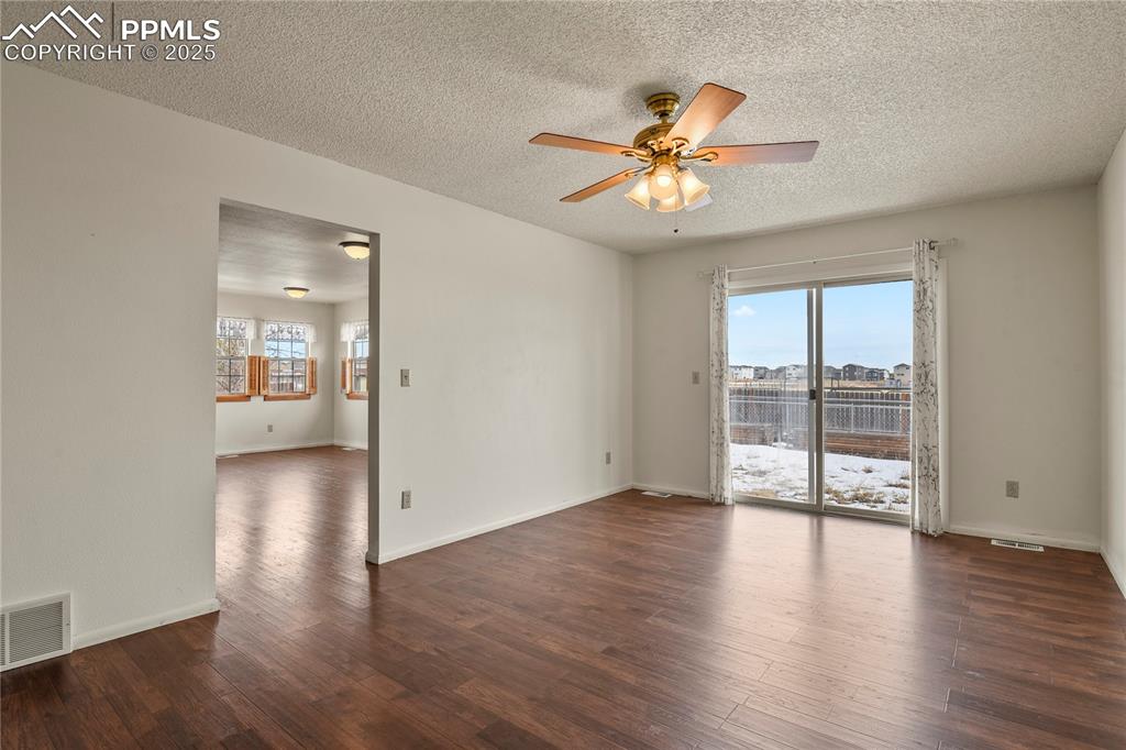 7875 Falcon Meadows Boulevard Peyton, CO 80831 - Photo 20 of 50 a view of an empty room with window and wooden floor