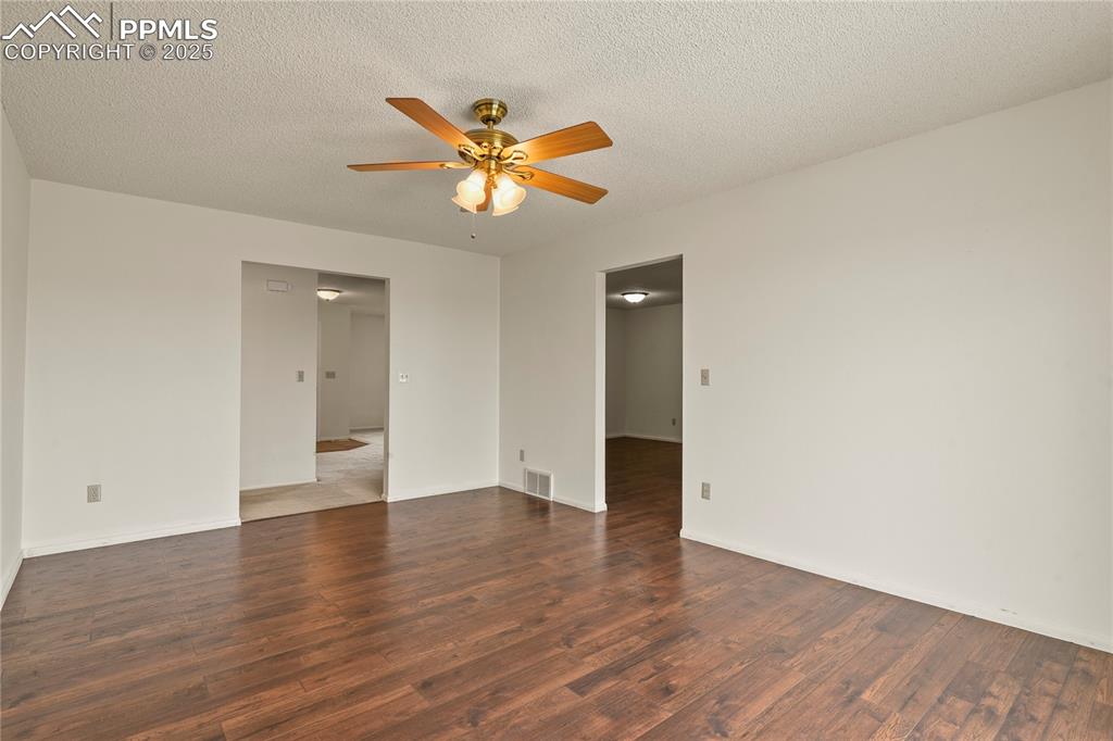 7875 Falcon Meadows Boulevard Peyton, CO 80831 - Photo 21 of 50 a view of an empty room with wooden floor and window