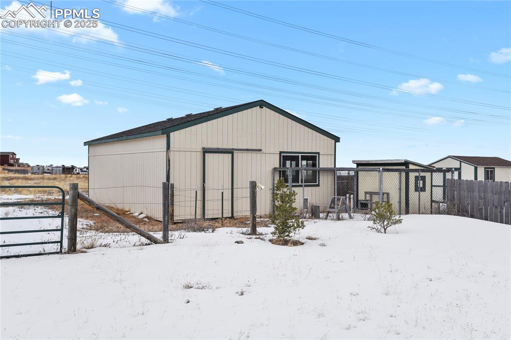 7875 Falcon Meadows Boulevard Peyton, CO 80831 - Photo 33 of 50 a view of a house with snow on the road