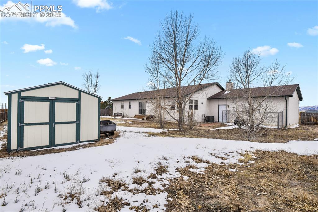 7875 Falcon Meadows Boulevard Peyton, CO 80831 - Photo 37 of 50 a front view of a house with a yard covered in snow